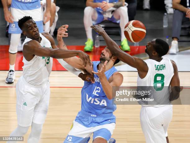 Miye Oni of Nigeria knocks the ball away from Marcos Delia of Argentina as Ekpe Udoh of Nigeria defends during an exhibition game at Michelob ULTRA...