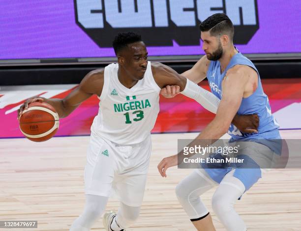Miye Oni of Nigeria drives against Patricio Garino of Argentina during an exhibition game at Michelob ULTRA Arena ahead of the Tokyo Olympic Games on...