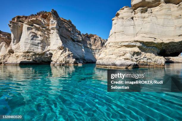 crystal clear turquoise water and mighty rock formations, kleftiko, milos, cyclades, greece - milos stock pictures, royalty-free photos & images