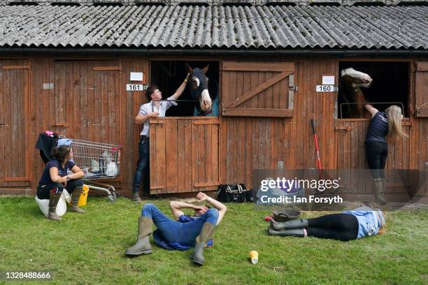 Stable hands and owners rest with their horses on the first day of the 162nd Great Yorkshire Show at the Harrogate Show Ground on July 13, 2021 in...