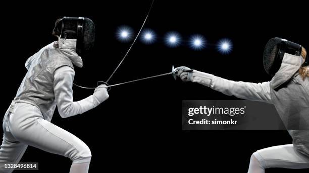 female fencing athletes competing . - fäktningsmask bildbanksfoton och bilder