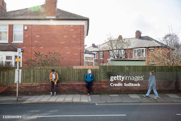 waiting for the bus during pandemic - coronavirus social distancing stock pictures, royalty-free photos & images