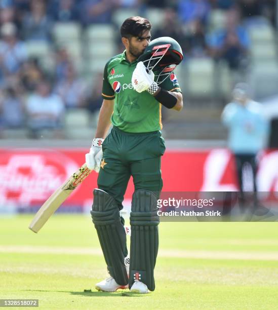 Babar Azam of Pakistan kisses his helmet after scoring 100 runs during the 3rd Royal London Series One Day International match between England and...