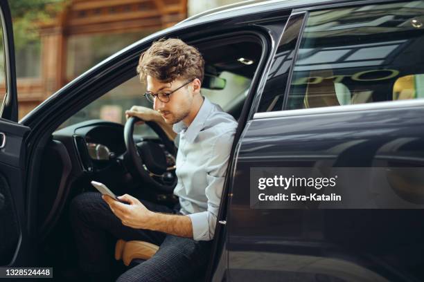 man driving his car - smartphone car stock pictures, royalty-free photos & images