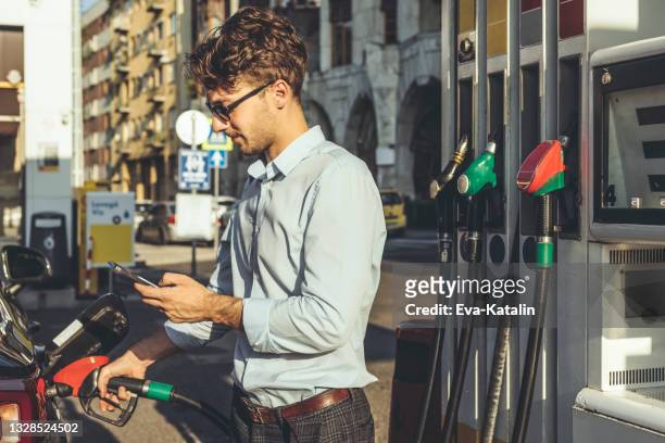 man at the gas station - biodiesel stock pictures, royalty-free photos & images