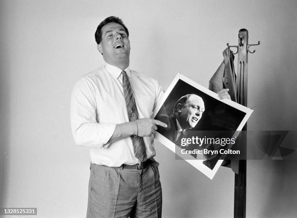 Derek Hatton, former deputy leader of Liverpool City Council and Labour Party politician, holds a photographed of Neil Kinnock, Labour Party leader,...