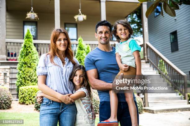 portrait of family in front of suburban home - family in front of home fotografías e imágenes de stock