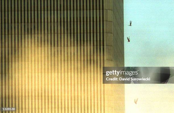 People jump to their deaths from the World Trade Center after it was hit by two planes and engulfed in smoke and flames during a suspected terrorist...