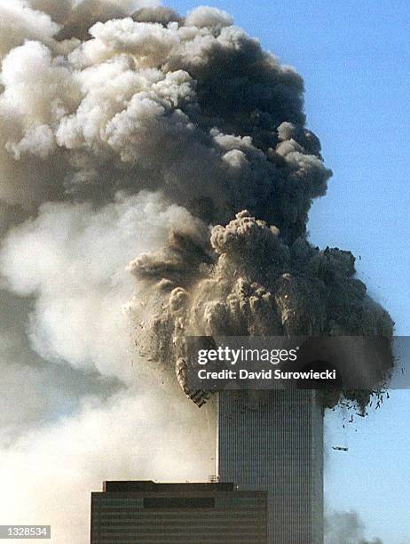 The World Trade Center''s top stories collapse after being hit by two planes during a suspected terrorist attack September 11, 2001 in New York City.