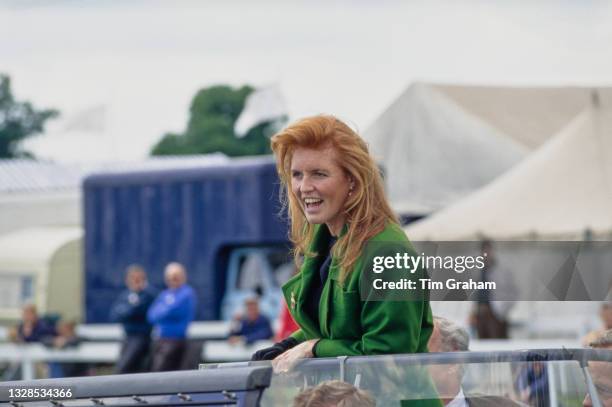British Royal Sarah, Duchess of York, wearing an emerald green coat as she is driven in an open-top vehicle at the South of England Show, an...