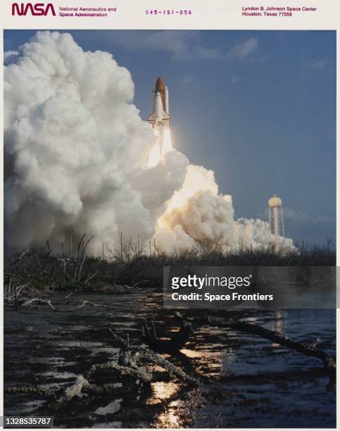 The Space Shuttle Atlantis creates a mountain of exhausts clouds as its as it soars off the launchpad and heads towards Earth Orbit with a crew of...