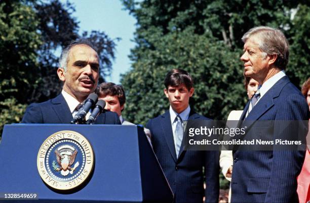 King Hussein I of Jordan speaks during a State Arrival ceremony on the White House's South Lawn, Washington DC, June 17, 1980. Listening are US...