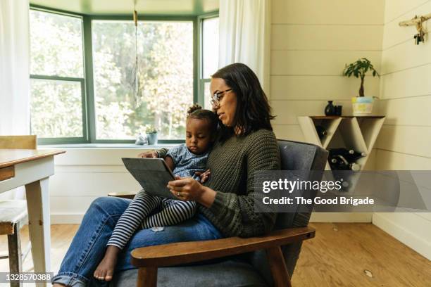 mother and daughters consulting with doctor in video call - telemedicine choicepix stock pictures, royalty-free photos & images