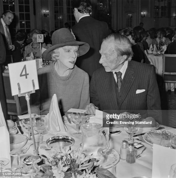 English aristocrat Lady Diana Cooper with J. Paul Getty at a dinner, UK, 28th October 1974.