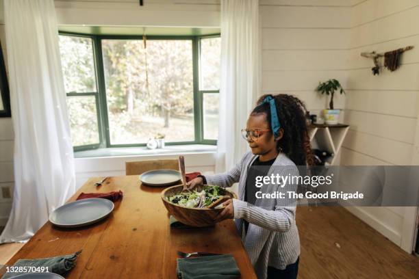young girl helping to prepare table for dinner - setting the table stock pictures, royalty-free photos & images