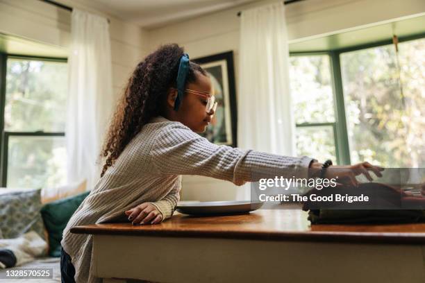 young girl setting table for dinner - setting the table stock pictures, royalty-free photos & images
