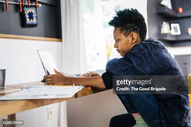 side view of teenage girl looking at laptop - blue hair stock pictures, royalty-free photos & images