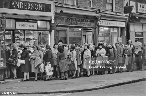 Customers queuing for bread during a strike by bakery workers, UK, 4th December 1974.