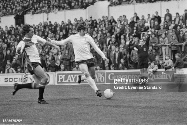 English footballer John Beck of Queens Park Rangers and Cyril Knowles of Tottenham Hotspur during a League Division One match at White Hart Lane in...