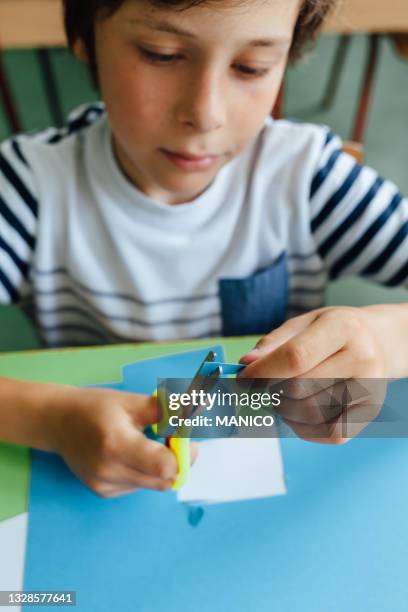 boy cutting paper at school - child cutting card stock pictures, royalty-free photos & images