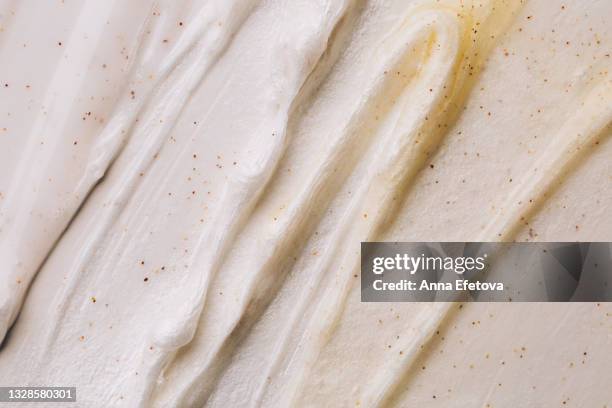 texture of beige body scrub with exfoliating particles. flat lay style - yellow milk stock-fotos und bilder