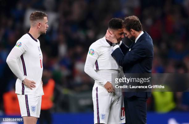 Gareth Southgate, Head Coach of England consoles Jadon Sancho following defeat in the UEFA Euro 2020 Championship Final between Italy and England at...