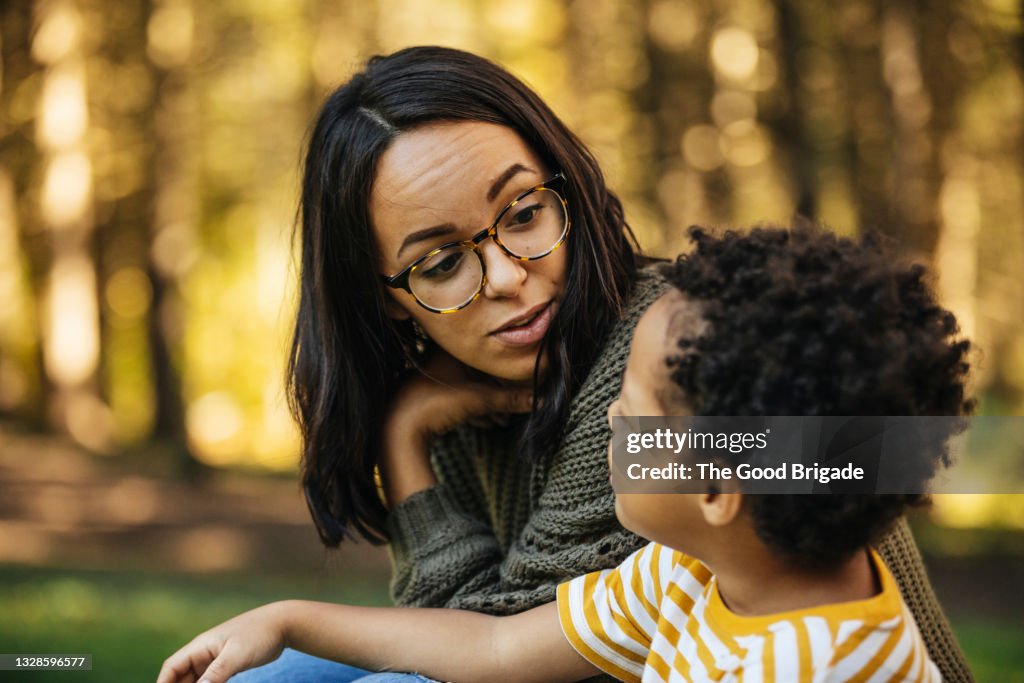 Mother talking to son outdoors