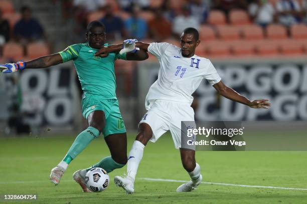 Jerry Bengtson of Honduras and goalkeeper Reice Charles Cook of Grenada fight for the ball during a Group D match as part of the 2021 CONCACAF Gold...