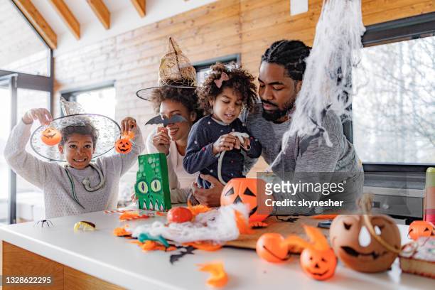 african american family making halloween decorations at home. - halloween stock pictures, royalty-free photos & images