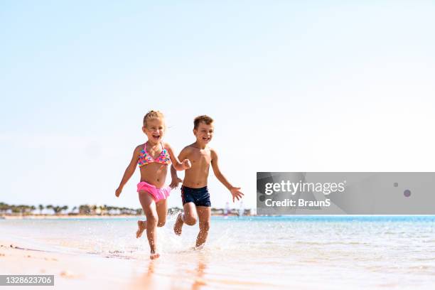 cheerful kids running in summer day on the beach. - egypt beach stock pictures, royalty-free photos & images