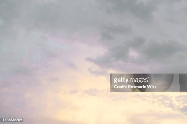 sky above pale yellow and purple evening clouds - grey overcast stock pictures, royalty-free photos & images