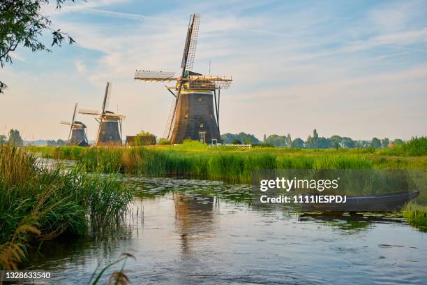 three mills during sunrise - netherlands windmill stock pictures, royalty-free photos & images