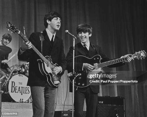 English rock and pop group The Beatles, from left, Ringo Starr, Paul McCartney and George Harrison perform on stage during rehearsals for the 1963...