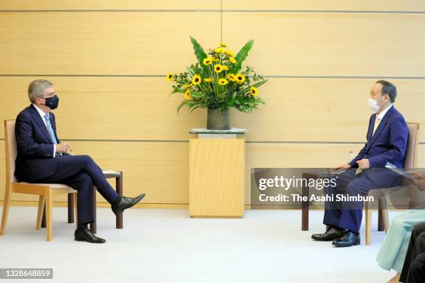 Japanese Prime Minister Yoshihide Suga and IOC President Thomas Bach talk during their meeting at the prime minister's office on July 14, 2021 in...