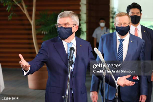 President Thomas Bach speaks to media after his meeting with Japanese Prime Minister Yoshihide Suga while IOC Vice President John Coates watches at...