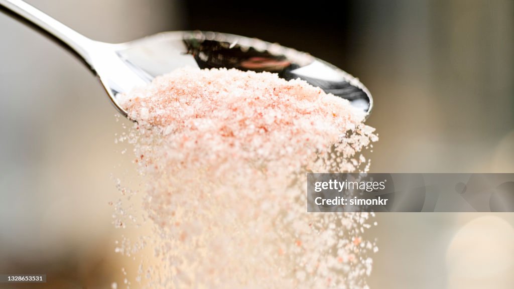 Himalayan salt falling off a spoon