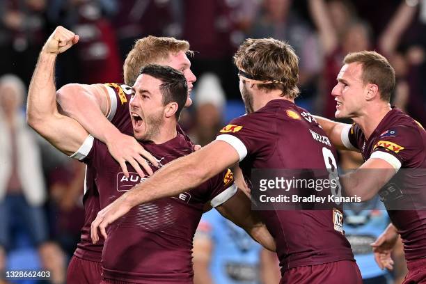 Ben Hunt of the Maroons celebrates with team mates after scoring a try during game three of the 2021 State of Origin Series between the New South...