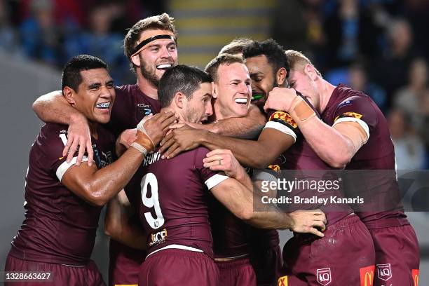 Ben Hunt of the Maroons celebrates with team mates after scoring his second try during game three of the 2021 State of Origin Series between the New...