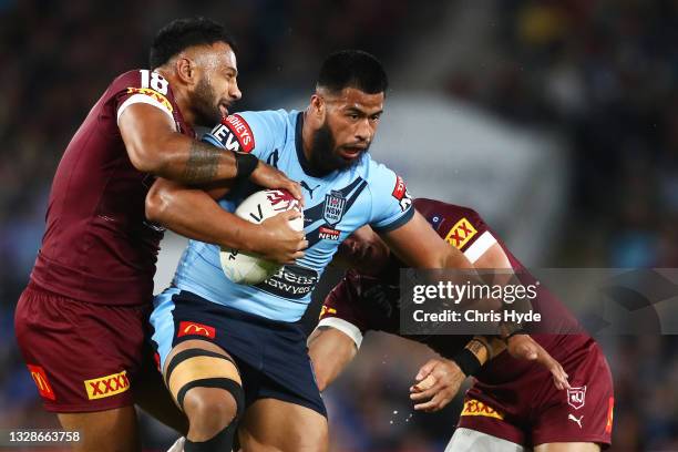 Payne Haas of the Blues is tackled during game three of the 2021 State of Origin Series between the New South Wales Blues and the Queensland Maroons...