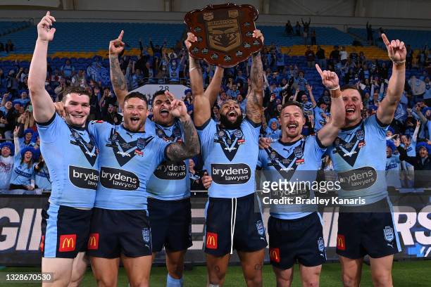 Josh Addo-Carr of the Blues holds aloft the Origin trophy and celebrates with team mates after winning the series 2-1 after game three of the 2021...