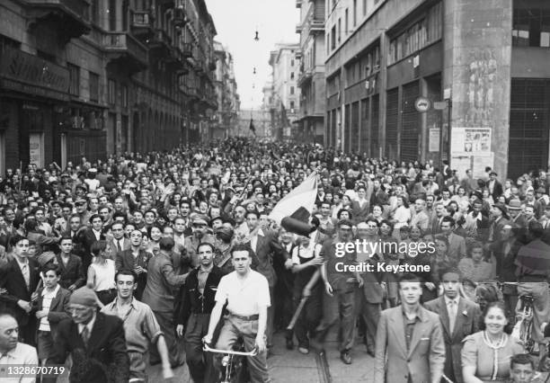 Civilians fill the streets of Milan to celebrate their liberation by Italian partizans from the Nazi German forces and Fascist regime of occupation...