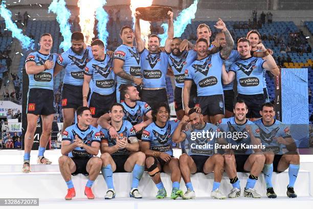 James Tedesco of the Blues holds aloft the Origin trophy and celebrates with team mates after winning the series 2-1 after game three of the 2021...