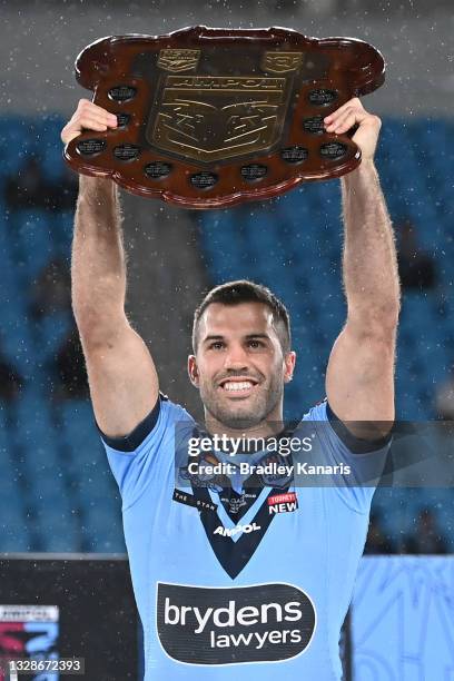 James Tedesco of the Blues holds aloft the Origin trophy after winning the series 2-1 after game three of the 2021 State of Origin Series between the...