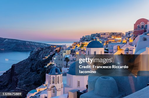 Oia, Santorini Island, Cyclades, Greece. Twilight, Houses and churches after sunset Oia, Santorini Island, Cyclades, Greece. Twilight, Houses and churches after sunset