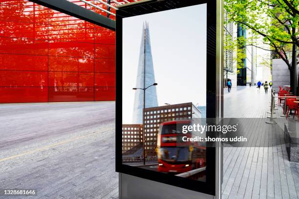 multi layered street scene of london - bus advertising stockfoto's en -beelden