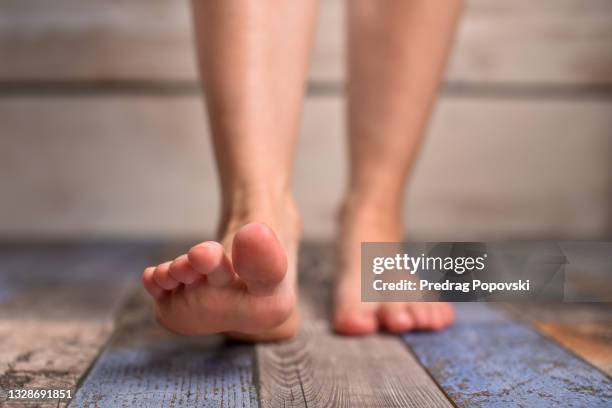 barefoot woman with clean feet stepping on floor - podiatrist stockfoto's en -beelden