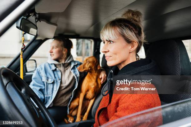 Single Mom Driving Car With Daughter And Pet Dog