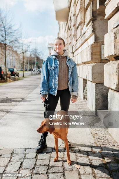 portrait of teenage girl walking pet dog - car pet barrier stock pictures, royalty-free photos & images