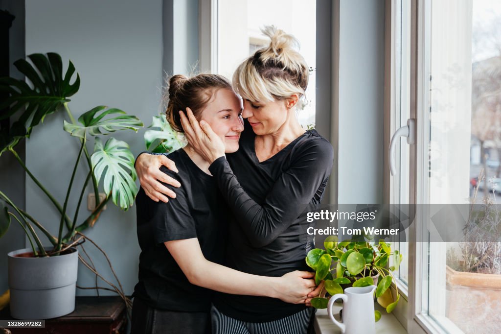 Single Mom Affectionately Hugging Teenage Daughter