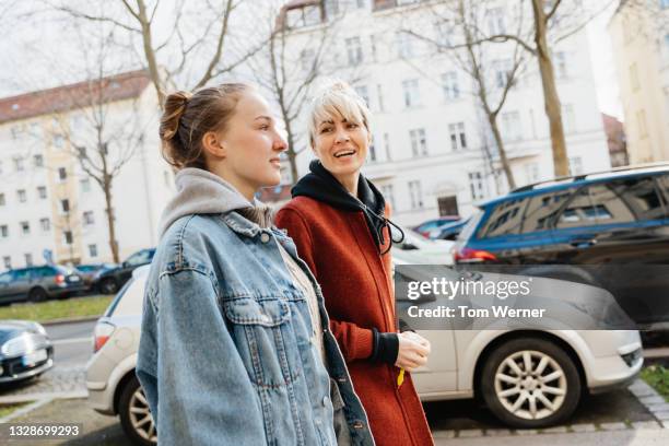 teenage girl out for walk with mom - two young women stock pictures, royalty-free photos & images